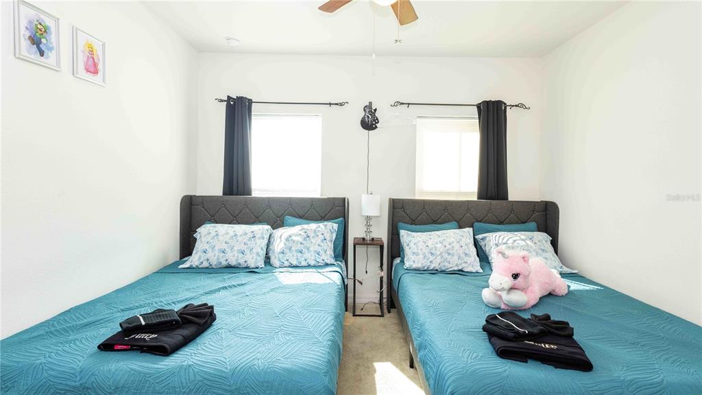 815 Montgomery Drive Davenport, FL 33897 - Photo 14 of 24 a bedroom with a bed and wooden floor