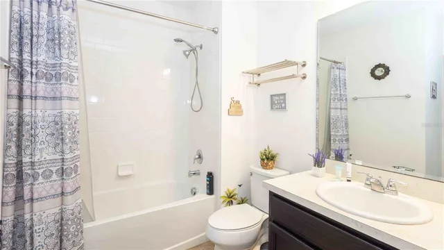 a bathroom with a granite countertop sink toilet a shower and a mirror