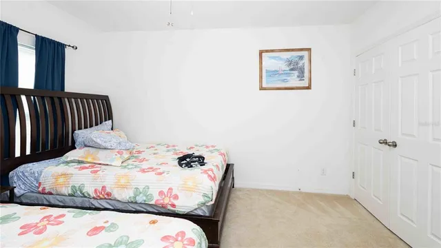 a bedroom with a bed and a painting on the wall
