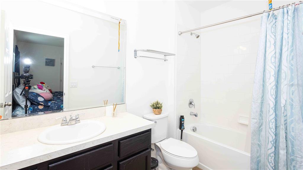 815 Montgomery Drive Davenport, FL 33897 - Photo 17 of 24 a bathroom with a sink a toilet and shower