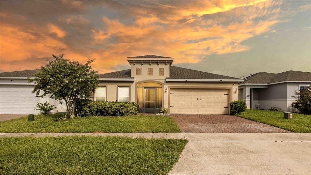 815 Montgomery Drive Davenport, FL 33897 - Photo 20 of 24 a front view of a house with a yard