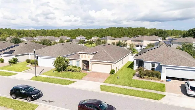a front view of a house with a garden and yard