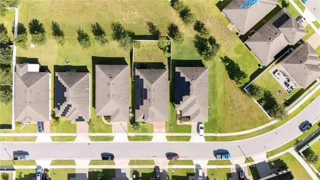 an aerial view of residential houses with outdoor space and swimming pool