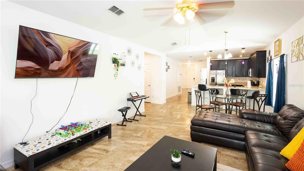 815 Montgomery Drive Davenport, FL 33897 - Photo 4 of 24 a living room with furniture and a flat screen tv