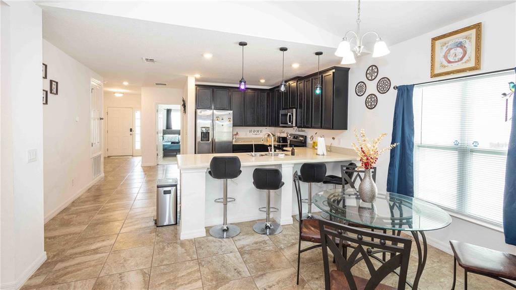 815 Montgomery Drive Davenport, FL 33897 - Photo 7 of 24 a dining room with furniture and a large window