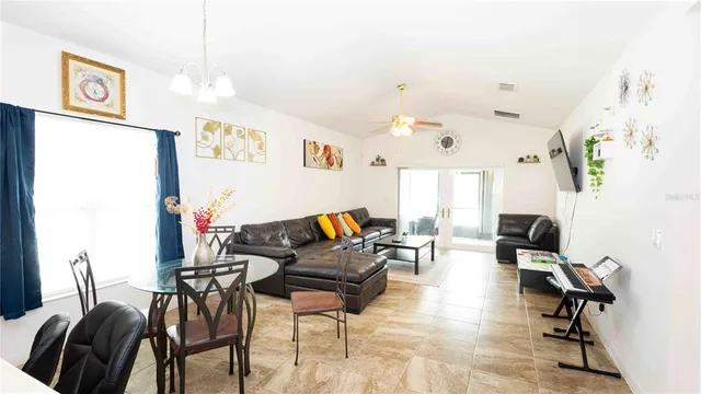 a living room with furniture and wooden floor
