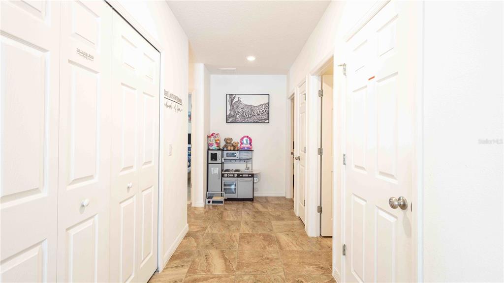 815 Montgomery Drive Davenport, FL 33897 - Photo 9 of 24 a view of a hallway with closet and bathroom
