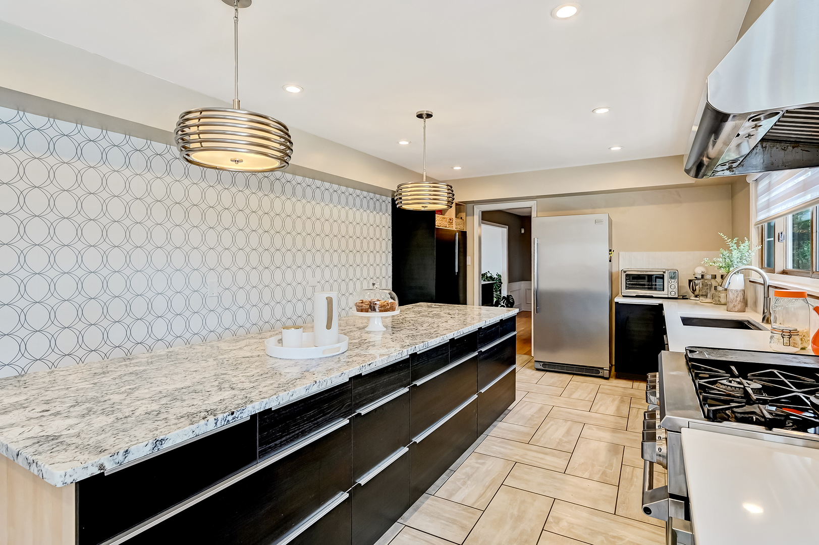 6750 County Line Lane Burr Ridge, IL 60527 - Photo 11 of 35 a kitchen with stainless steel appliances granite countertop a sink a stove and a refrigerator