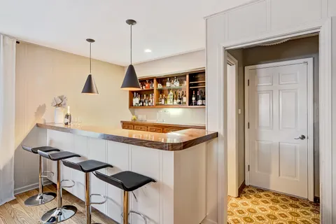 a kitchen with granite countertop a stove a sink and a refrigerator