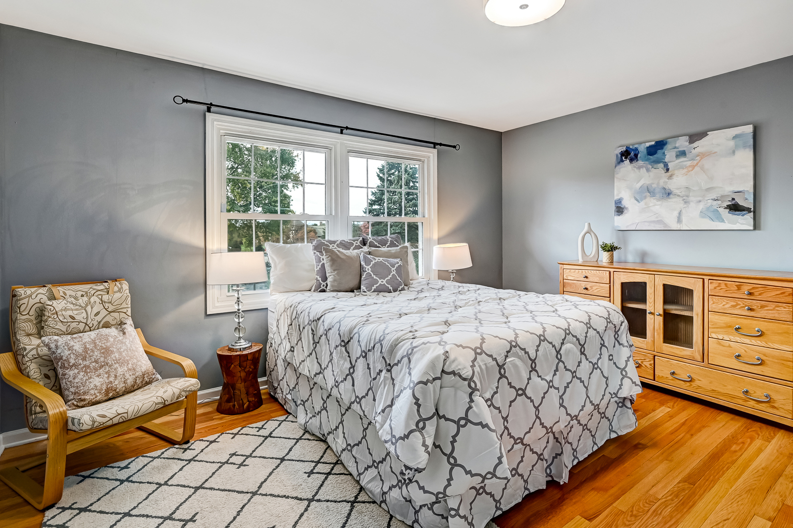 6750 County Line Lane Burr Ridge, IL 60527 - Photo 22 of 35 a bedroom with a bed and wooden floor