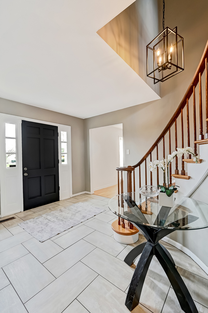6750 County Line Lane Burr Ridge, IL 60527 - Photo 3 of 35 a view of entryway and hall with dining room