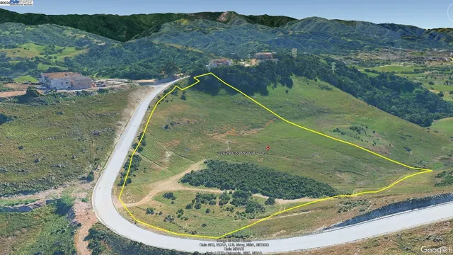 an aerial view of a residential houses with outdoor space and river