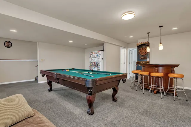 a room with furniture and pool table