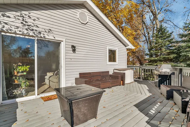 a view of a dinning table and chairs in patio of the house