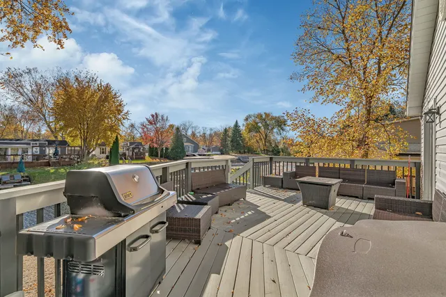 a roof deck with couches and city view