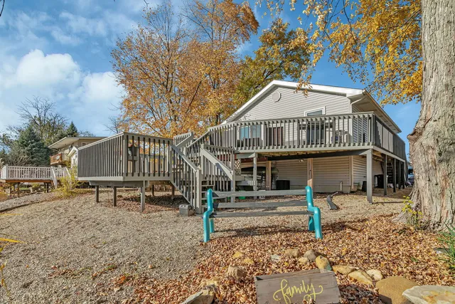 a house that has a tree in front of a house