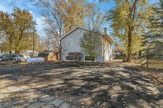 an aerial view of a house with a yard