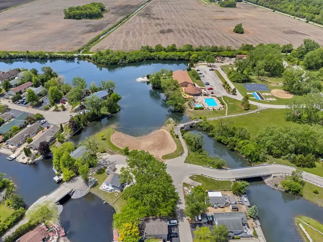 an aerial view of lake residential house with swimming pool and outdoor space