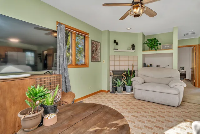 a living room with furniture and a potted plant