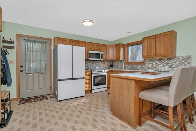 a kitchen with a refrigerator a stove top oven and a sink
