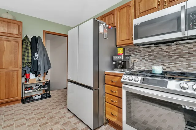 a kitchen with stainless steel appliances granite countertop a stove and a microwave with cabinets