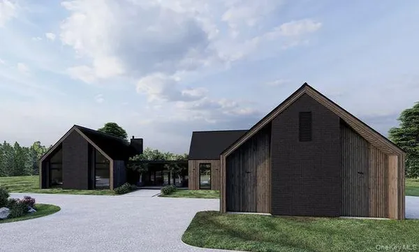 a backyard of a house with lots of green space and wooden fence