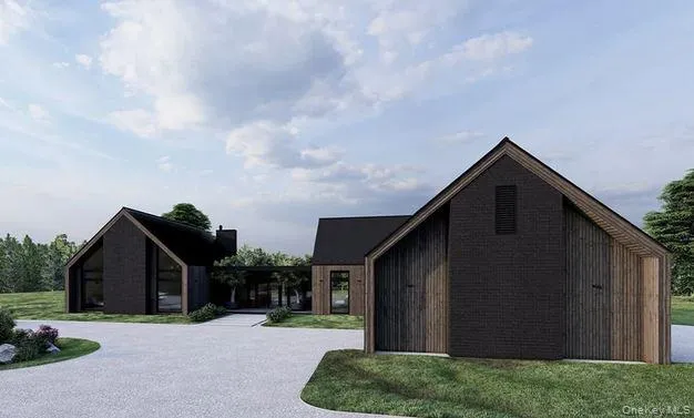 a backyard of a house with lots of green space and wooden fence