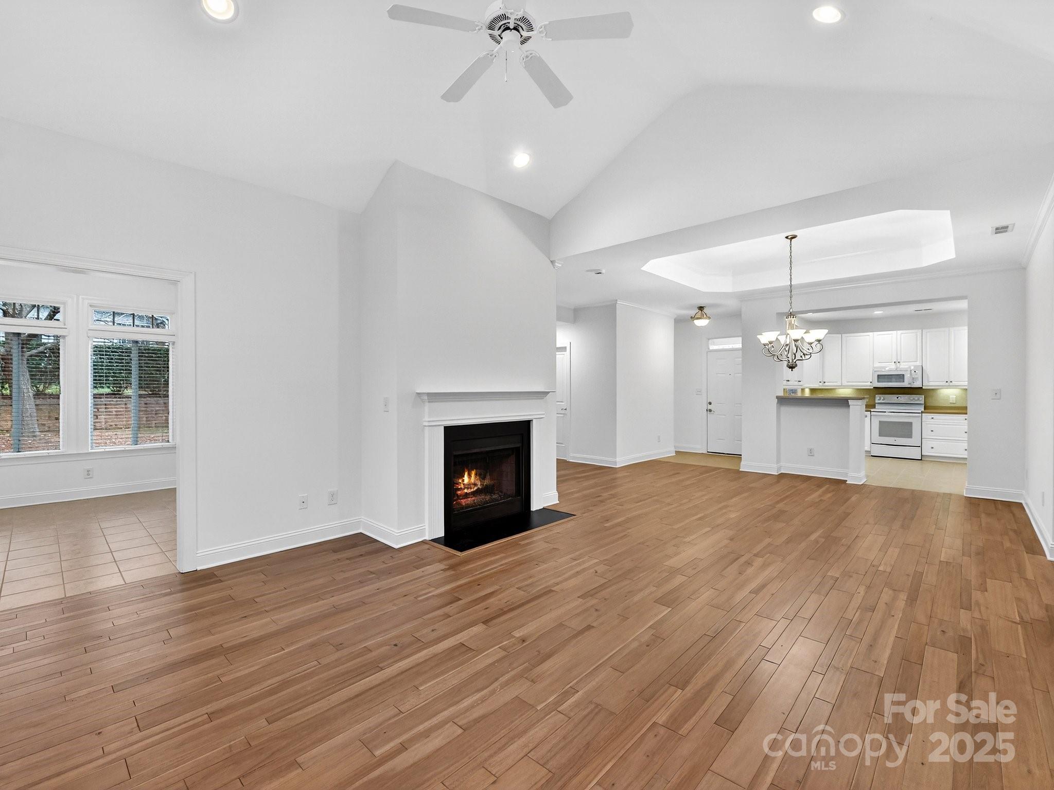 2963 Bellasera Way Matthews, NC 28105 - Photo 12 of 46 a view of empty room with wooden floor and fireplace