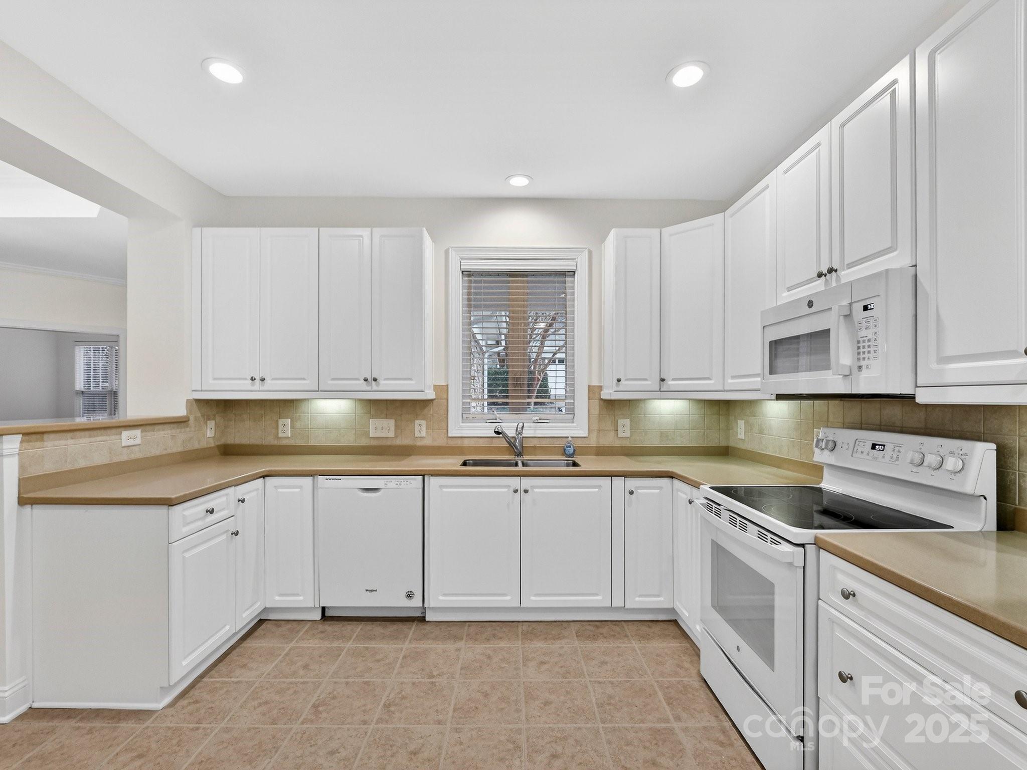 2963 Bellasera Way Matthews, NC 28105 - Photo 15 of 46 a kitchen with cabinets appliances and a sink