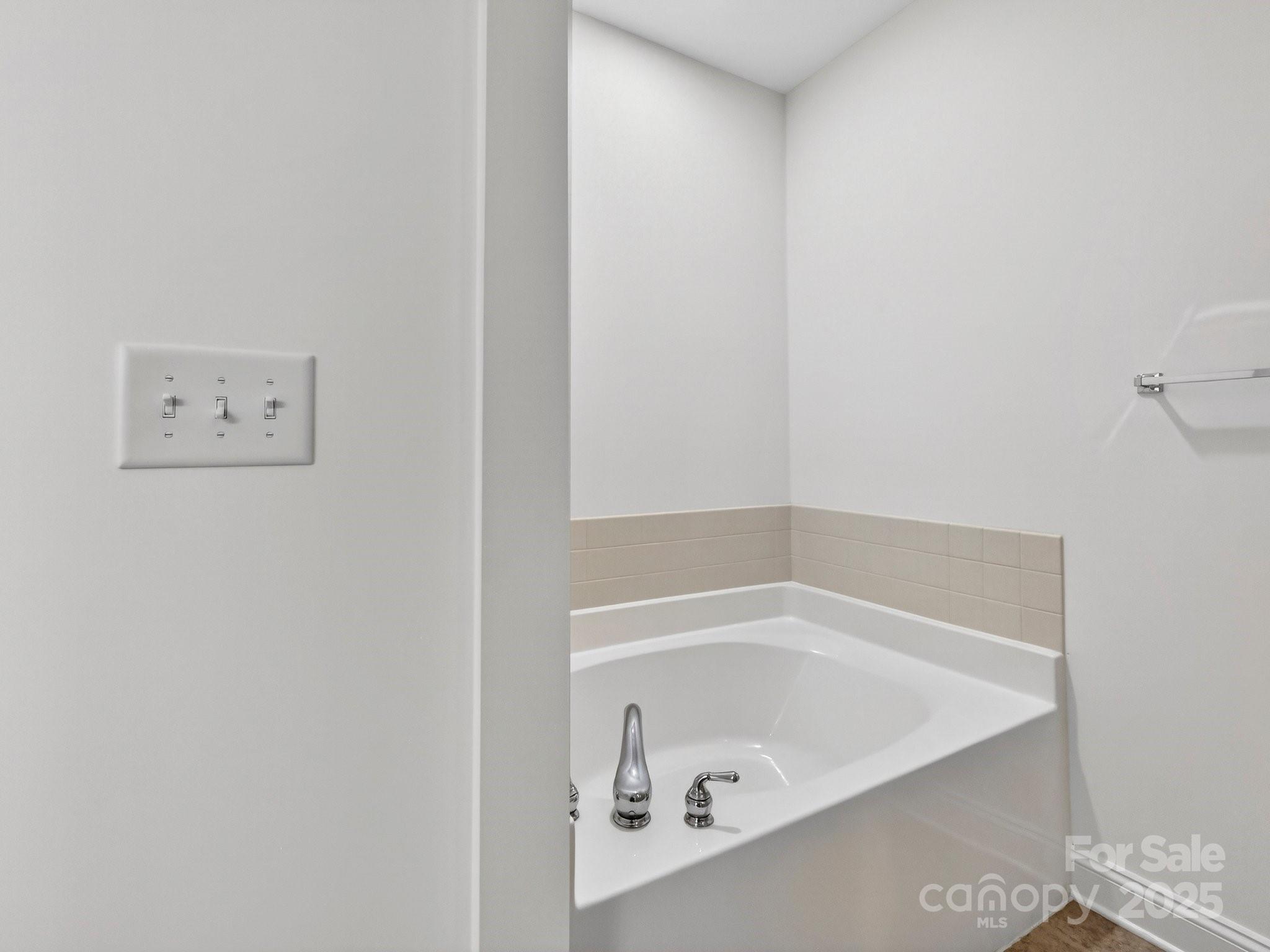 2963 Bellasera Way Matthews, NC 28105 - Photo 26 of 46 a bathroom with a bathtub