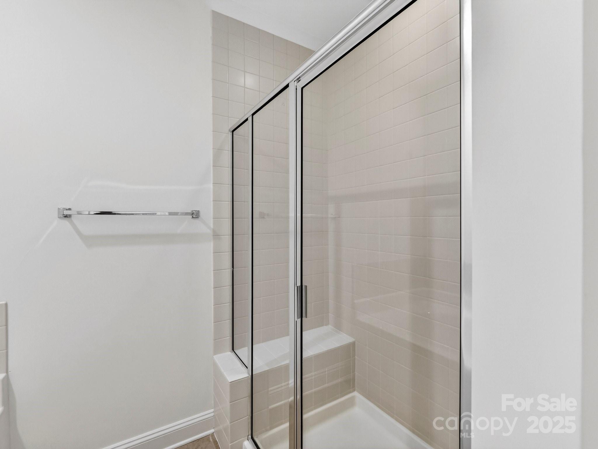 2963 Bellasera Way Matthews, NC 28105 - Photo 27 of 46 a bathroom with a glass shower door