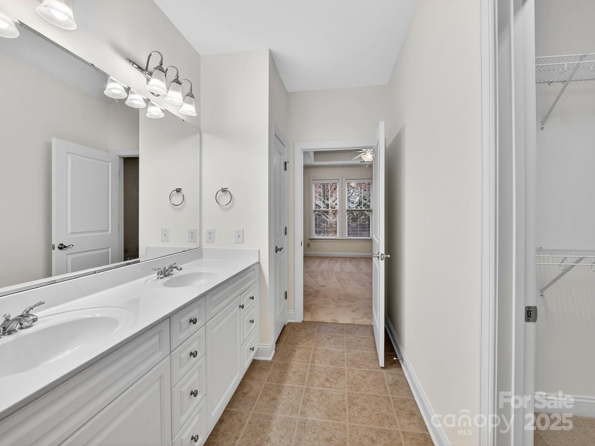 2963 Bellasera Way Matthews, NC 28105 - Photo 28 of 46 a spacious bathroom with a granite countertop sink a mirror and a shower