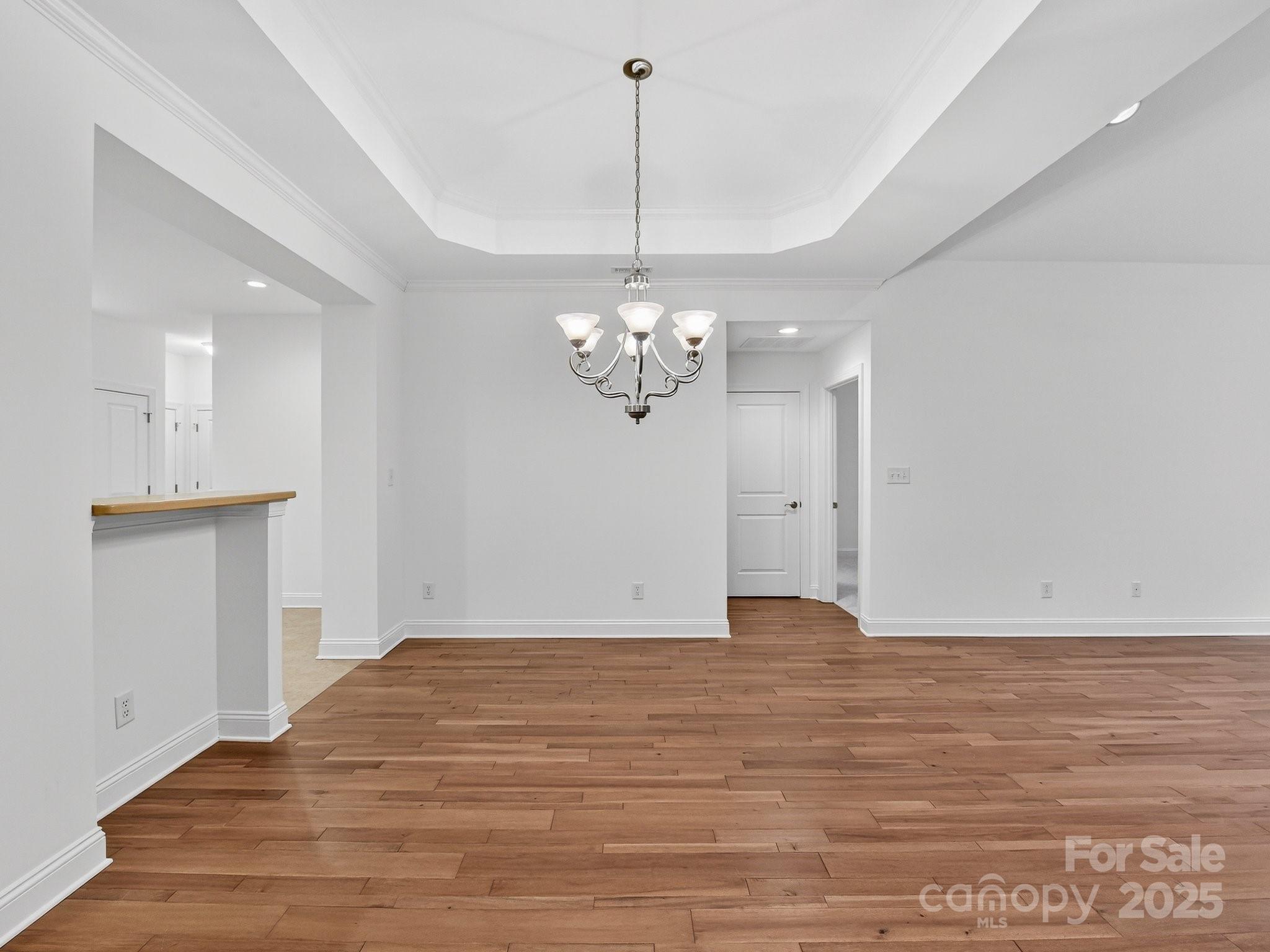 2963 Bellasera Way Matthews, NC 28105 - Photo 8 of 46 a view of a room with wooden floor and chandelier