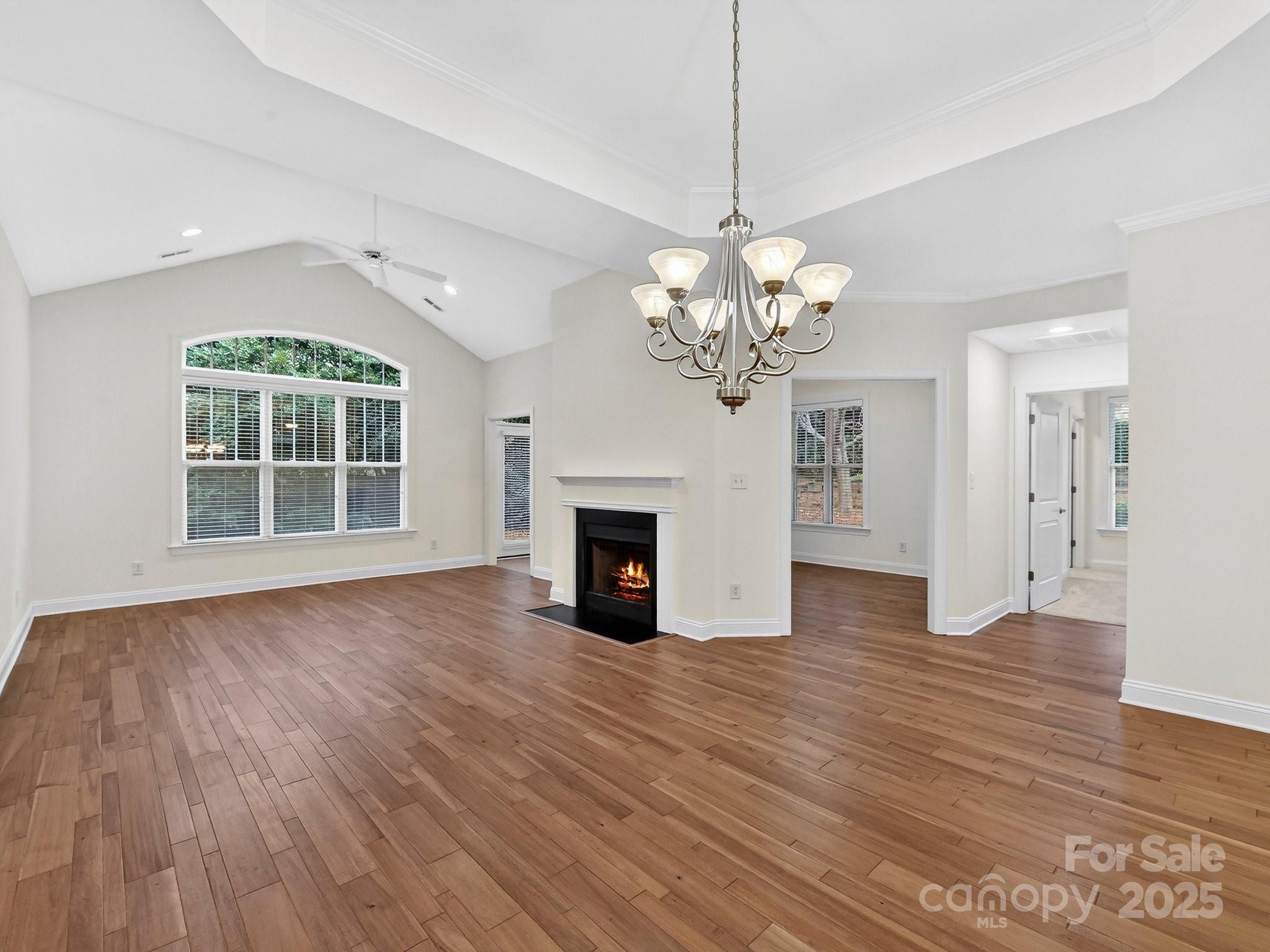 2963 Bellasera Way Matthews, NC 28105 - Photo 9 of 46 a view of a room with wooden floors and fireplace