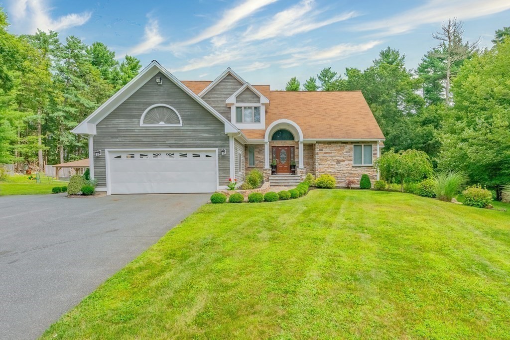 a front view of house with yard and green space