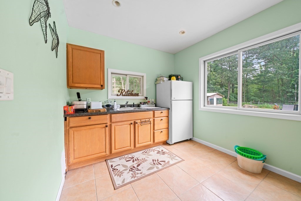 28 Gammons Road Acushnet, MA 02743 - Photo 31 of 39 a kitchen with stainless steel appliances a refrigerator sink and cabinets