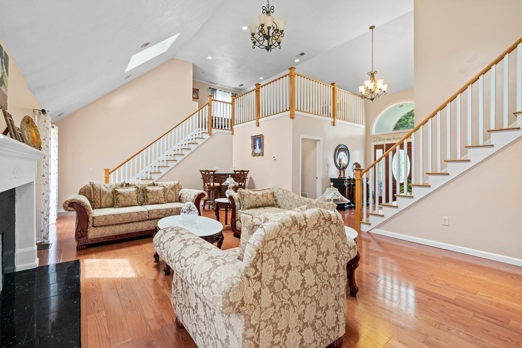 28 Gammons Road Acushnet, MA 02743 - Photo 9 of 39 a living room with fireplace furniture and a wooden floor