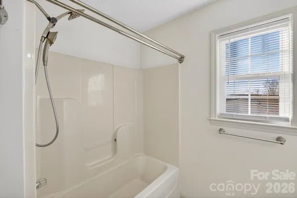 a bathroom with a shower and a window