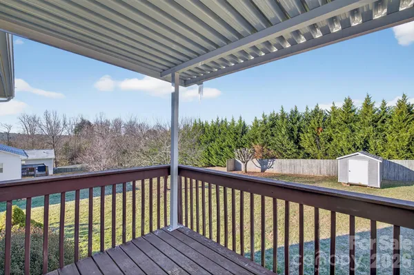 a balcony with wooden floor and outdoor space