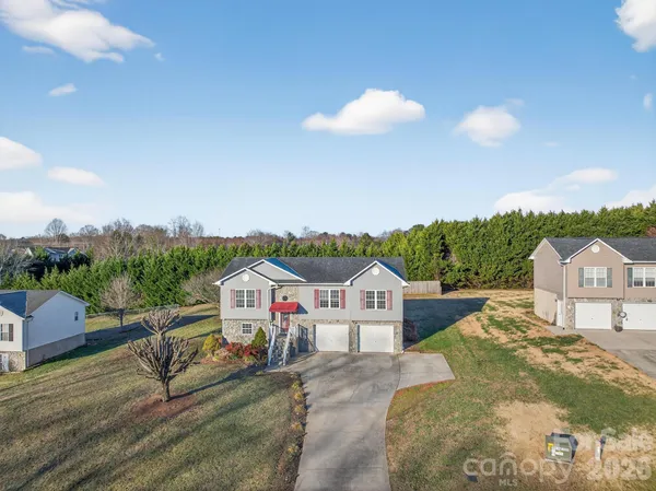 a view of a house with wooden fence