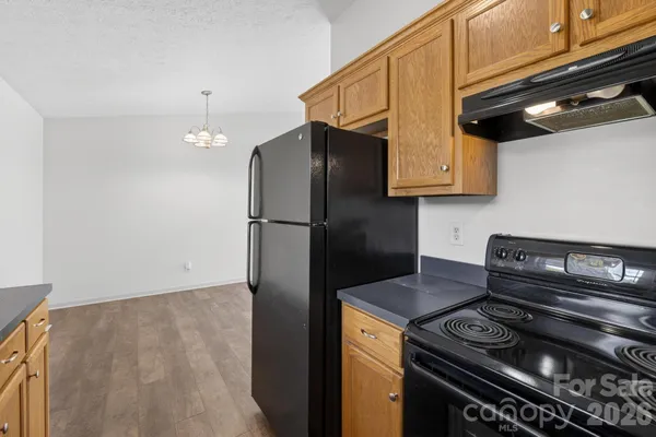 a kitchen with a stove and a refrigerator