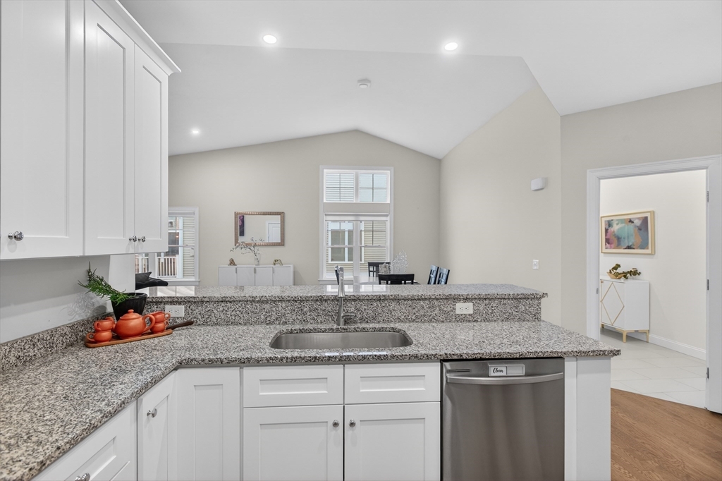 10 Logans Run, Unit 10 Millbury, MA 01527 - Photo 18 of 42 a kitchen with granite countertop a sink and cabinets
