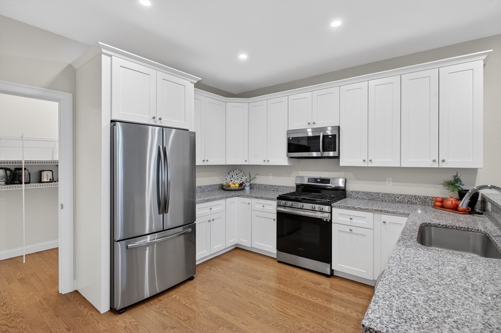 10 Logans Run, Unit 10 Millbury, MA 01527 - Photo 20 of 42 a kitchen with a refrigerator sink and microwave