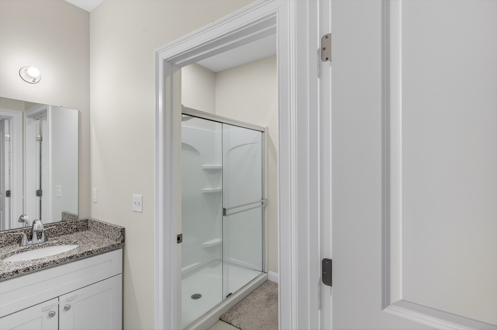 10 Logans Run, Unit 10 Millbury, MA 01527 - Photo 25 of 42 a bathroom with a granite countertop sink a mirror and a shower