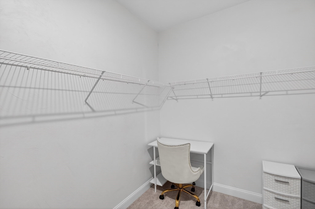 10 Logans Run, Unit 10 Millbury, MA 01527 - Photo 26 of 42 a view of a room with racks on the wall