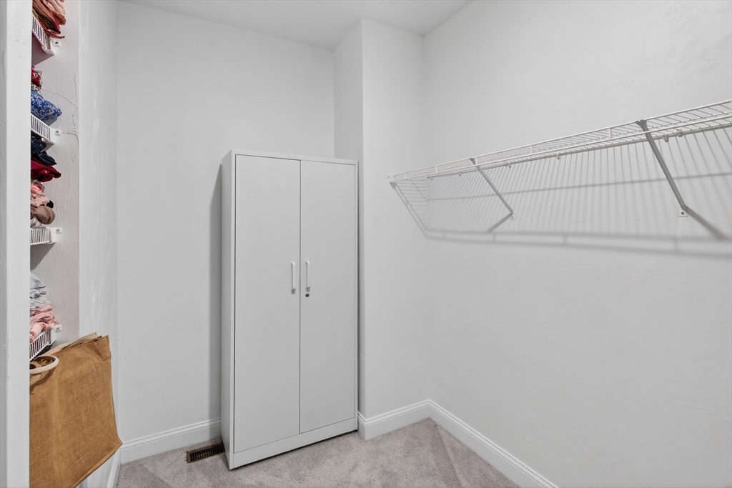 10 Logans Run, Unit 10 Millbury, MA 01527 - Photo 27 of 42 a view of storage and utility room with racks on the wall
