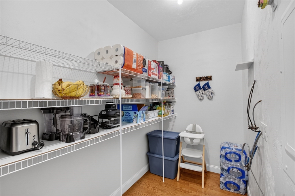 10 Logans Run, Unit 10 Millbury, MA 01527 - Photo 28 of 42 a cabinet with wine bottles and glasses on it