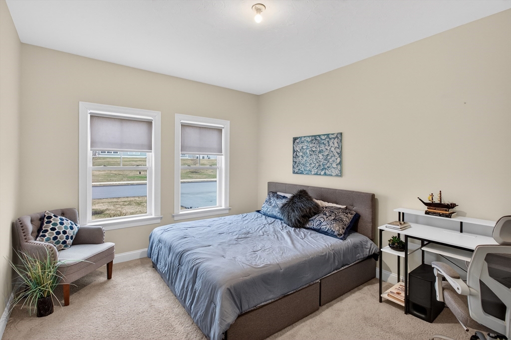10 Logans Run, Unit 10 Millbury, MA 01527 - Photo 31 of 42 a bedroom with a bed and a couch