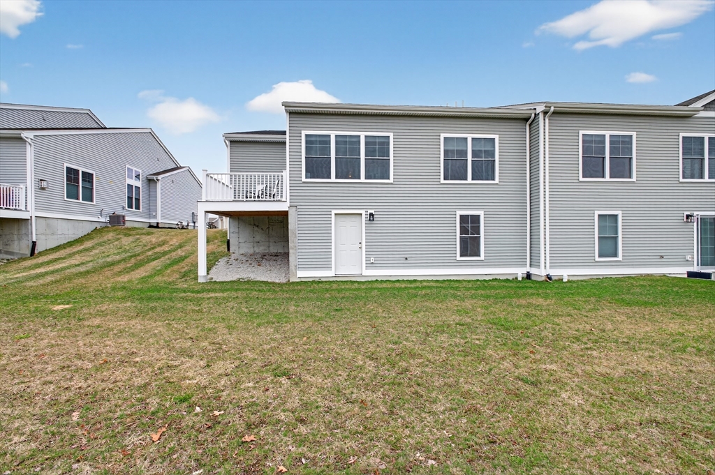 10 Logans Run, Unit 10 Millbury, MA 01527 - Photo 40 of 42 a view of a house with a yard