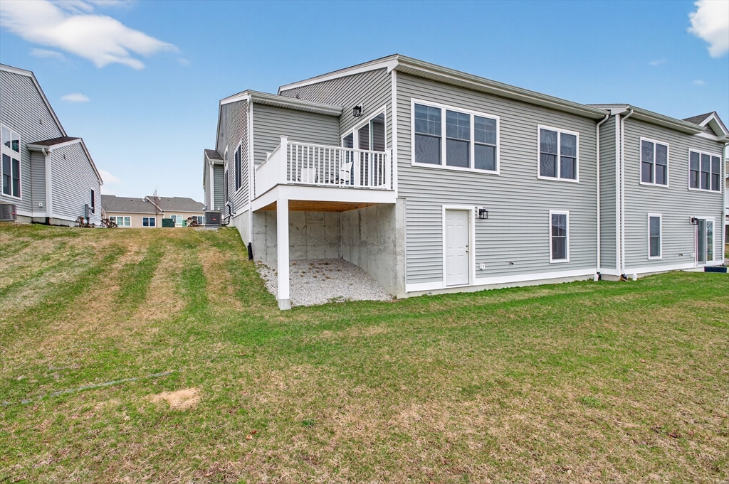 10 Logans Run, Unit 10 Millbury, MA 01527 - Photo 41 of 42 a front view of a house with a yard